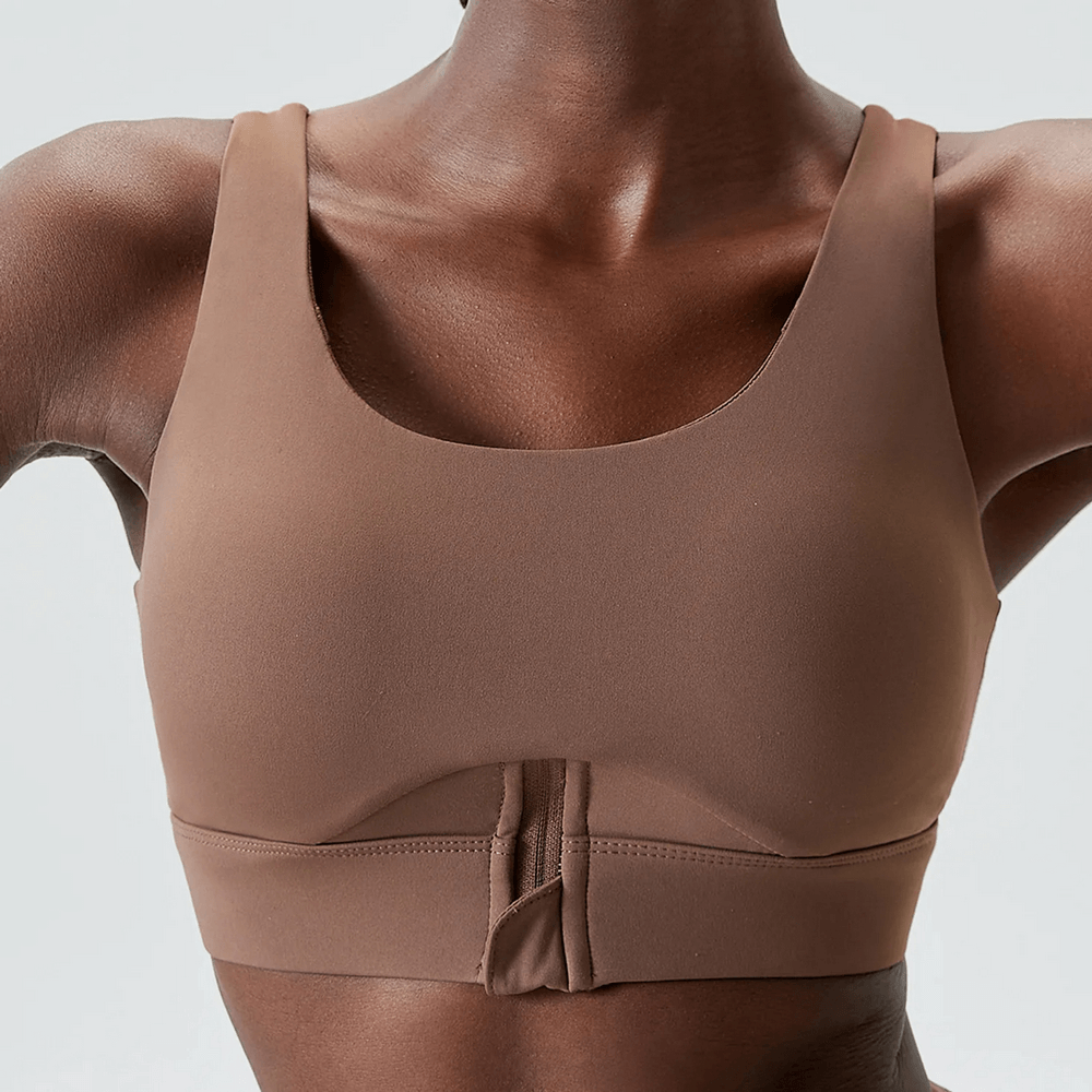 Vibrant brown yoga fitness bra with zip closure, breathable and flexible sportswear for high-impact workouts, solid color design.